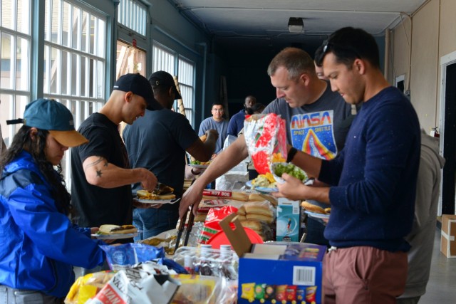 Soldiers and family members of the 229th Military Intelligence Battalion dig into food during the battalion’s Cadre Appreciation Day at Presidio of Monterey, Calif., July 1.