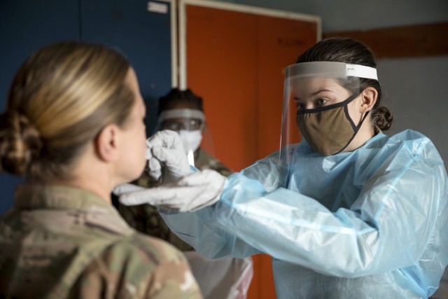 (FARKE AIRFILED, Albania) --- Spc. Elizabeth Porter, a field medic with the 1-131st Aviation Regiment, swabs a soldier’s nose for a Covid-19 test, May 16, 2021. Every soldier participating in Defender Europe 21 must take multiple tests to ensure...