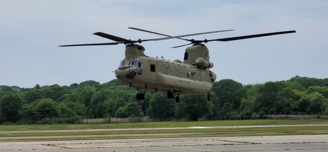 A CH-47 Chinook helicopter hovers for the first time in two years at the Connecticut National Guard&#39;s 1109th Theater Aviation Support Maintenance Group in Groton, Conn. June 2, 2021. This helicopter was battle damaged after a hard landing while serving in Iraq and had been sitting in Kuwait since 2018 awaiting repairs.