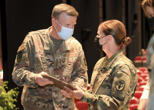Mons, Belgium – U.S. Air Force Gen. Tod D. Wolters, Supreme Allied Commander Europe (SACEUR), presents a farewell gift to U.S. Army Col. Kathleen G. Spangler prior to a change of command ceremony where Spangler relinquished command of Supreme Headquarters Allied Powers Europe (SHAPE) Healthcare Facility and U.S. Army Health Clinic Brussels to U.S. Army Col. Michael D. Ronn, at SHAPE, Belgium, June 24.