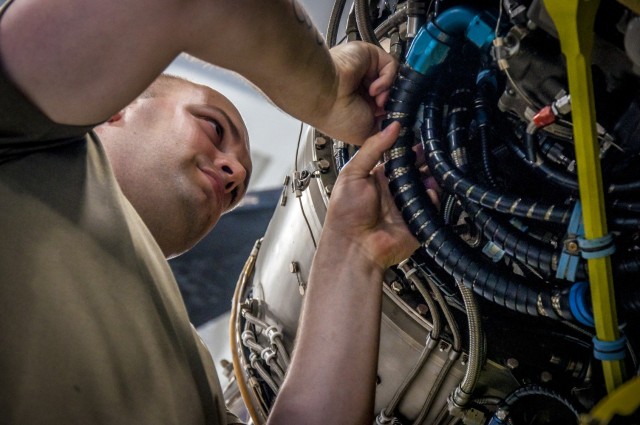 U.S. Army Cpl. Zachary Tallis, a CH-47 Chinook Mechanic with the Connecticut National Guard's 1109th Theater Aviation Support Maintenance Group, works on the rear engine of a helicopter that was battle damaged from a hard landing while serving in Iraq in the maintenance bay of the Connecticut National Guard's 1109th Theater Aviation Support Maintenance Group in Groton, Conn. June 22, 2021. The TASMG recovered this helicopter from Kuwait and performed a complete overhaul of the aircraft in order to get it back into the Army's operational fleet.