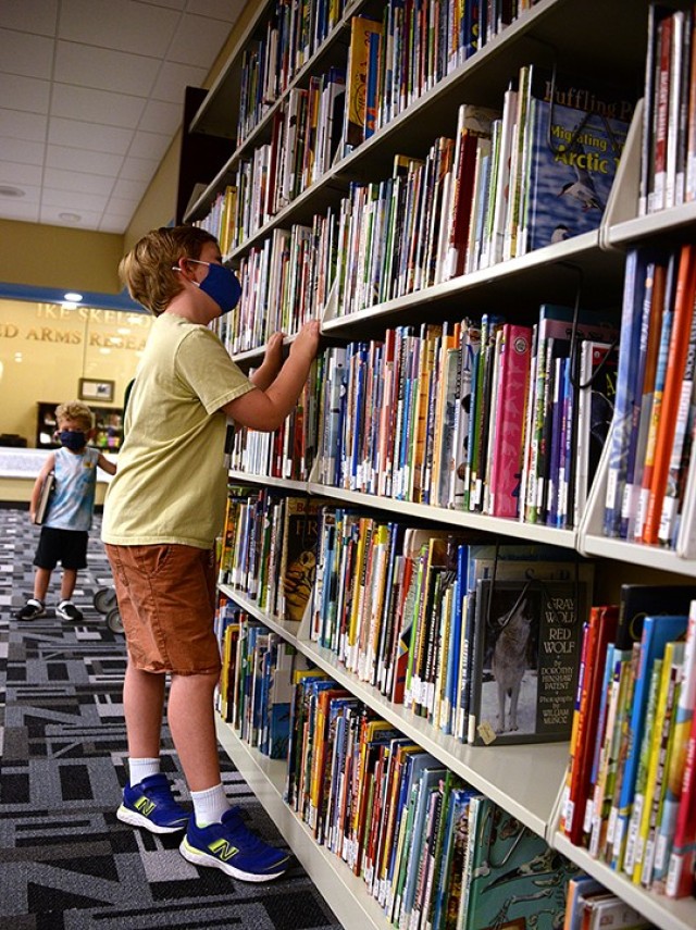 Six-year-old Ruby Norman and her 3-year-old brother Rex search for books July 6 in the children's room of the Combined Arms Research Library. Photo by Prudence Siebert/Fort Leavenworth Lamp
