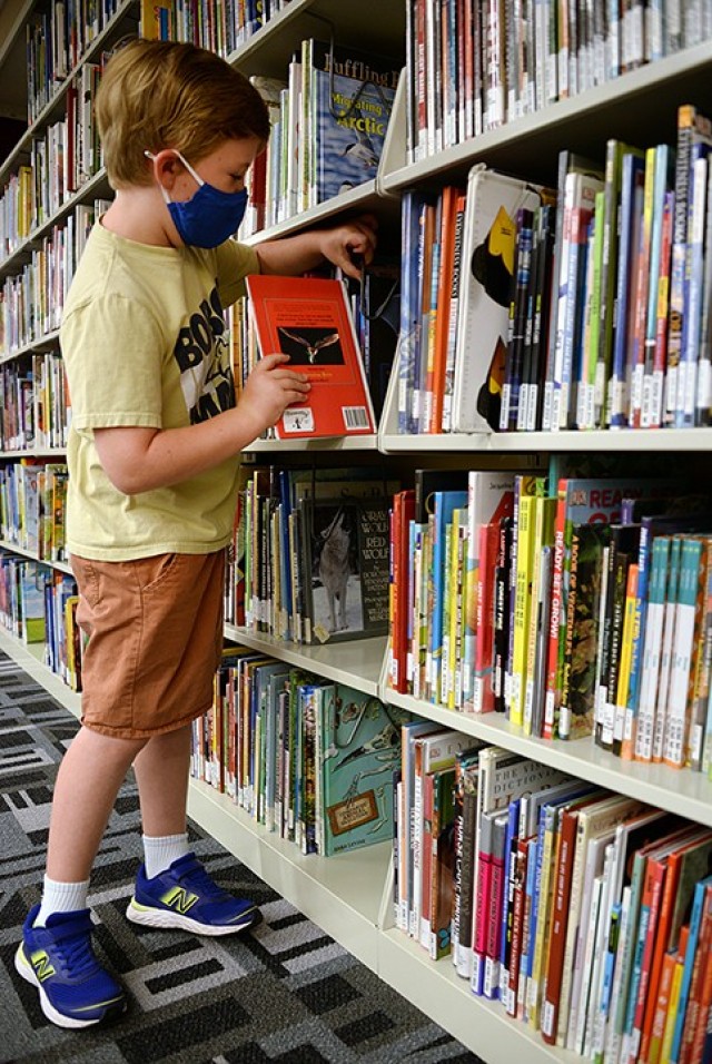 Six-year-old Ruby Norman finds a few books about bats July 6 in the children's room of the Combined Arms Research Library. Photo by Prudence Siebert/Fort Leavenworth Lamp