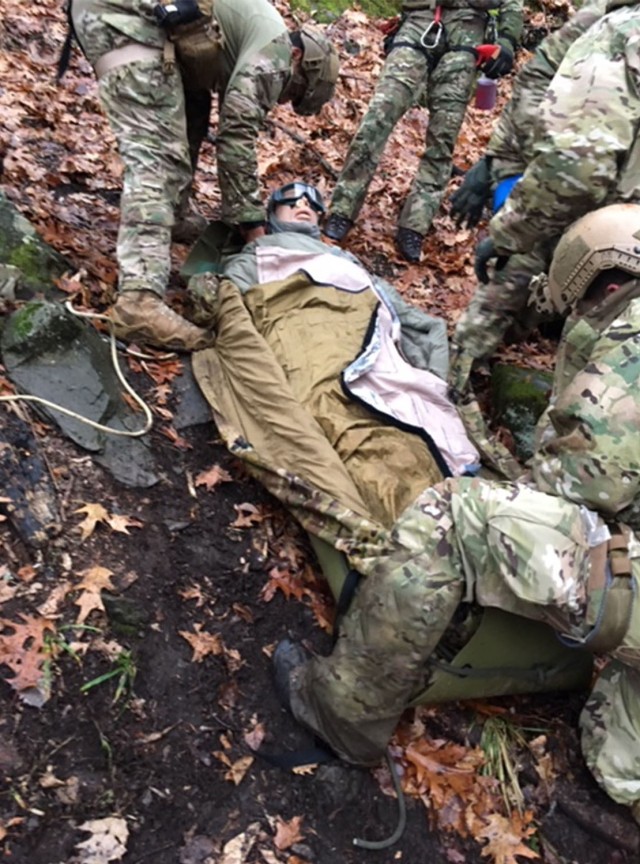 Photo of a casualty being packaged for a rough terrain evacuation.