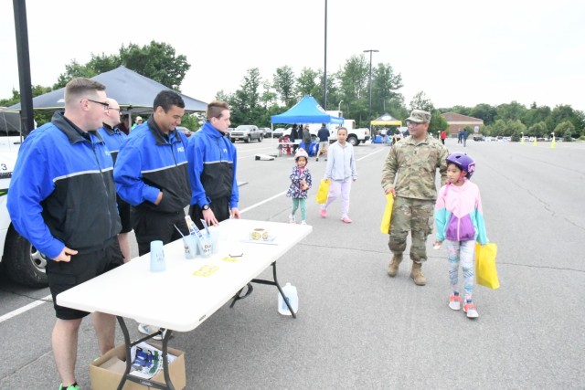 Members of the Fort Drum Bike Patrol speak with community members about safety July 7 during the annual Bike Rodeo. At the event, children strapped on their helmets and peddled their way through a safety course at the Magrath Sports Complex...