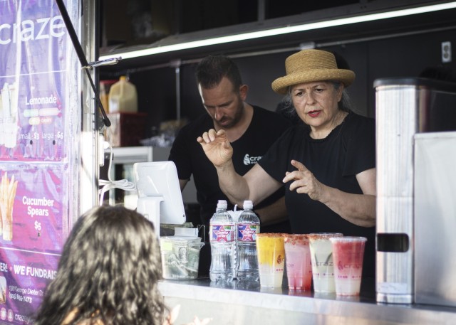 A food vendor tends to thirsty park goers during Pop Goes the Fort, the on-post Independence Day celebration, at Fort Bliss, Texas, July 4, 2021.