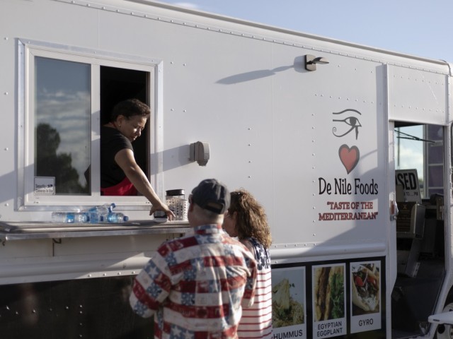 A food vendor tends to hungry park goers during Pop Goes the Fort, the on-post Independence Day celebration, at Fort Bliss, Texas, July 4, 2021.