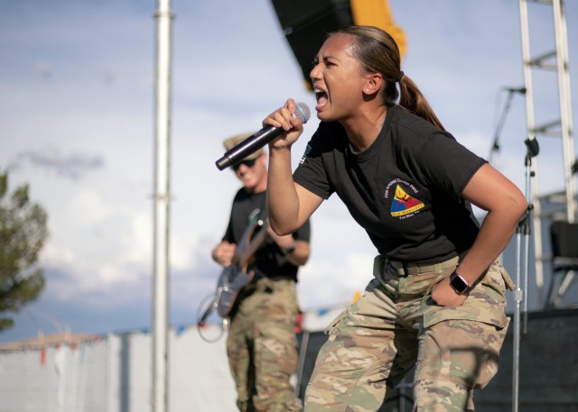 Spc. Pierre-Marie Colton joins Iron Will, the 1st Armored Division Band’s rock band, for a performance at Pop Goes the Fort at Fort Bliss, Texas, July 4, 2021. Hosted by Fort Bliss FMWR, Pop Goes the Fort is the installation’s annual Independence Day celebration.