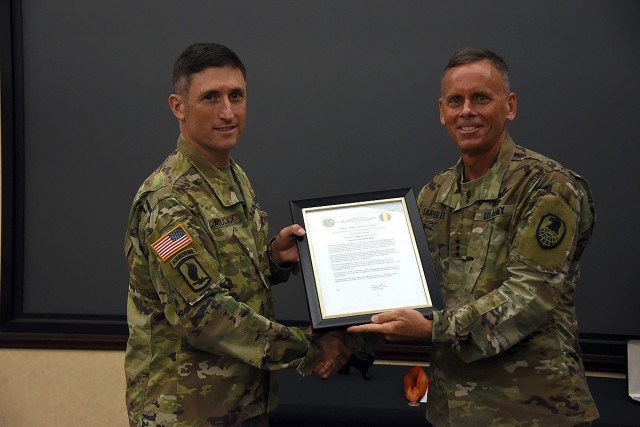 Col. David J. Mulack receive his charter as the incoming Army Capability Manager for Space and High Altitude from Lt. Gen. Daniel L. Karbler, commanding general, U.S. Army Space and Missile Defense Command, during a Change of Charter ceremony at the command’s Redstone Arsenal, Alabama, headquarters, July 9. The ACM SHA, part of SMDC’s Space and Missile Defense Center of Excellence, serves as the Army’s centralized fielded force integrator for space and high altitude operations. Mulack takes over the position from Col. Timothy G. Dalton, who is leaving the command for a new assignment. (U.S. Army photo by Carrie David Campbell)
