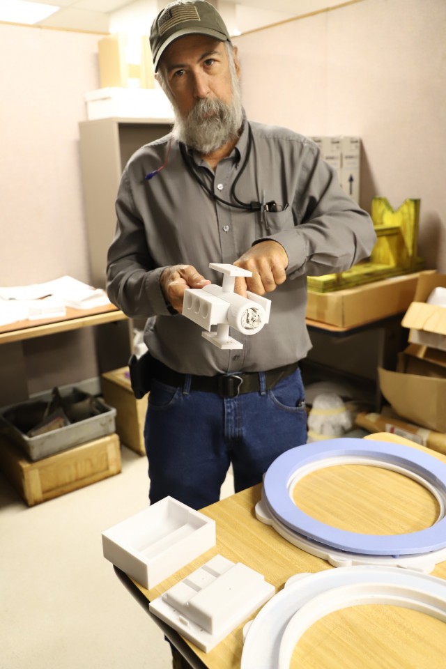 Mark Mireles, Tool Engineer, proudly displays several 3D printed shop aids at Corpus Christi Army Depot