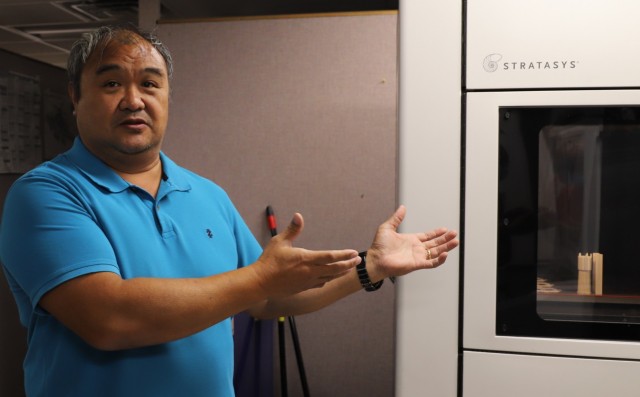 Ronnie Cervania, Mechanical Engineer, proudly displays shop aid at Corpus Christi Army Depot