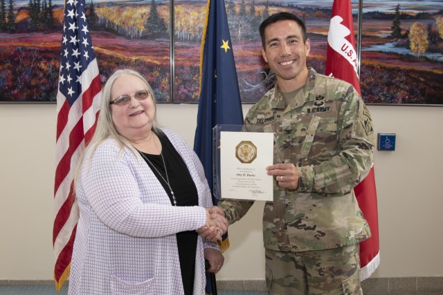Amy Burke, workforce management specialist, receives a 50-year Army Length of Service Award from Col. Damon Delarosa, commander of the U.S. Army Corps of Engineers – Alaska District, during a ceremony on June 24 at Joint Base...