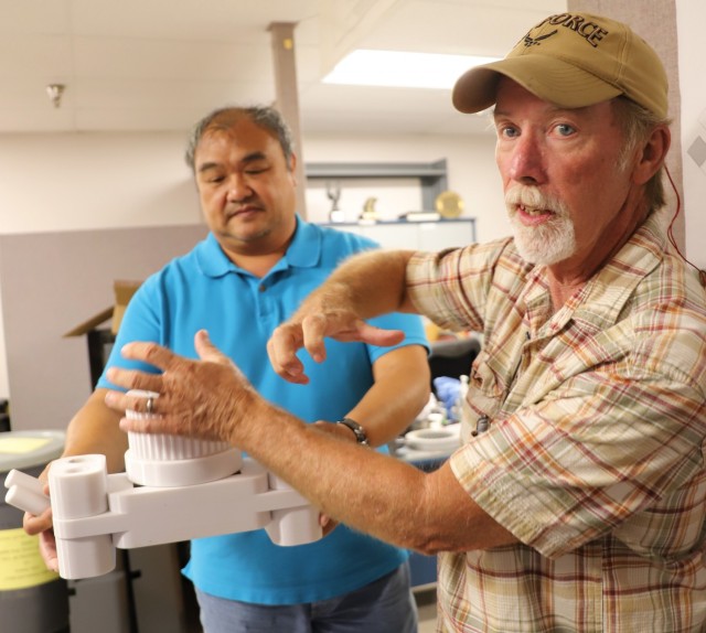 Ronnie Cervania, Mechanical Engineer (Left), and Falko Buchanan, Engineering Technician (Right) proudly talk shop aid at Corpus Christi Army Depot