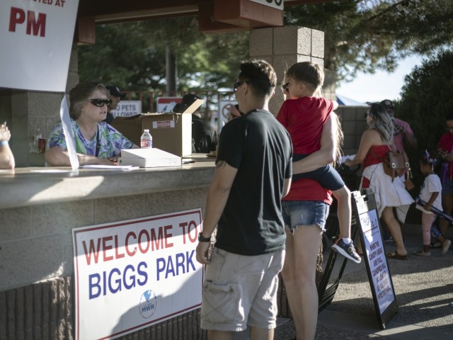 Volunteers talk to guests at the entrance of Biggs Park during Pop Goes the Fort at Fort Bliss, Texas, July 4, 2021. According to FMWR, more than two dozen volunteers joined their event staff for the annual Independence Day celebration.