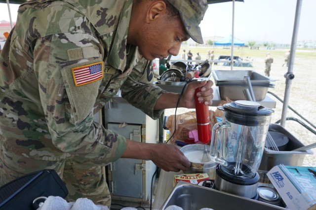 Sgt Harvey of 581st Quartermaster Field Feeding Company helps prepare his team's dessert during the Field Feeding Company Competition on Camp Humphreys.

U.S. Army photo by 1st Lt Brianna Griffin, 498th CSSB