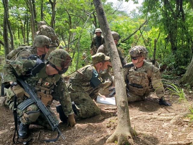 U.S. Army 1st Lt. Tyler Gness, a mortar platoon leader with 1st Battalion, 28th Infantry Regiment “Black Lions,” 3rd Infantry Division, speaks through a translator to his counterparts from the Japan Ground Self-Defense Force during mortar training at Aibano Training Area, Japan, June 30, 2021. Orient Shield is the largest U.S. Army and JGSDF bilateral field training exercise being executed at various locations throughout Japan to enhance interoperability and test and refine multi-domain and cross-domain operations.