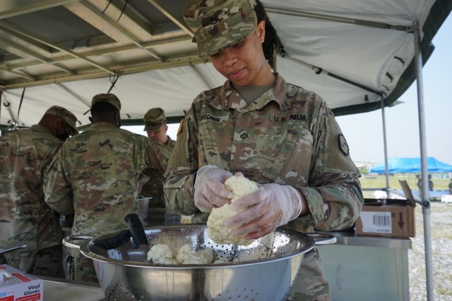 Private 1st Class Carol Brown of 541st Quartermaster Field Feeding Company prepares buffalo cauliflower wings during the Field Feeding Company Competition on Camp Humphreys.

U.S. Army photo by 1st Lt. Brianna Griffin, 498th CSSB
