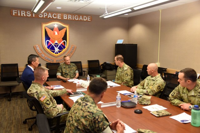 U.S. Army Space and Missile Defense Command leadership briefs U.S. Marine Corps Maj. Gen. David Furness, assistant deputy commandant for plans, policy and operations, on SMDC’s operations at 1st Space Brigade headquarters at Fort Carson, Colorado, July 1. The 1st Space Brigade will soon begin a new initiative to train Marine teams in space-related fields to support joint force warfighters. (U.S. Army photo by Sgt. 1st Class Aaron Rognstad/RELEASED)