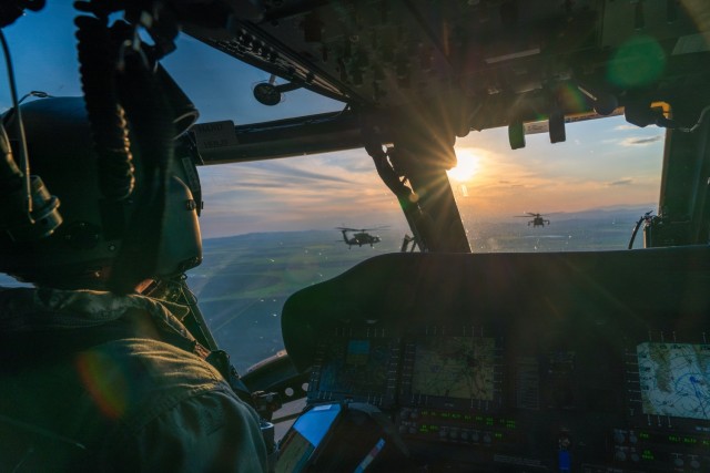 U.S. Army Chief Warrant Officer 3 Geoffrey Kinney, a UH-60 pilot assigned to the 12th Combat Aviation Brigade, Wings of Victory, flies his Black Hawk in formation en route back to base after maritime operations crew certification flights over the...