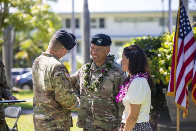 U.S. Army Sustainment Command commanding general Maj. Gen. Chirs Mohan congratulates 402nd AFSB outgoing commander Col. Anthony T. Walters and his wife Natalie.