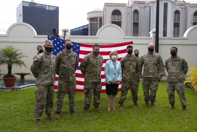 Soldiers assigned to 75th Troop Command, Kentucky National Guard, and the U.S. Ambassador to Guyana Sarah Ann Lynch (center), pose for a photo, after completing their Oath of Renlistment, given by Lt. Col. Timothy Stark, commander, 75th TC (left),...