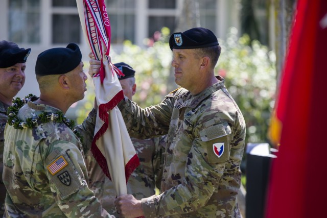 402nd Army Field Support Brigade Command Sgt. Maj. Adam Lepley passes the brigade's colors to Col. Anthony T. Walters during the brigade's change of command ceremony on July 9, 2021.