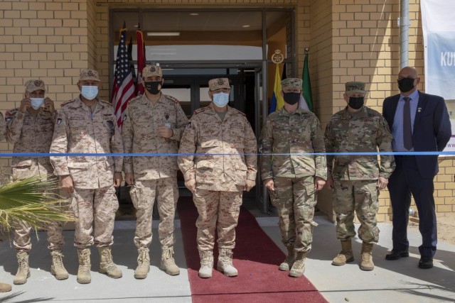 Kuwaiti and American service members and civilians stand together before cutting the ribbon at the new Patriot Fire Site, Site #7, Kuwait, July 5, 2021. Both American and Kuwaiti organizations came together to plan, design, resource, and construct...