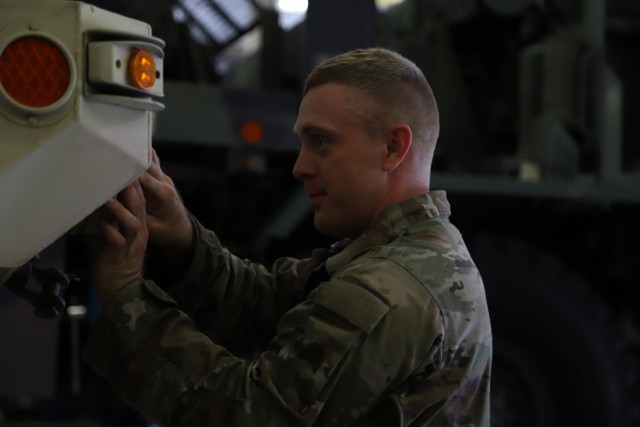 U.S. Army Spc. Joseph G. Muir Jr., an all wheels mechanic at V Corps, works on a vehicle at Fort Knox, Kentucky, June 9, 2021. Muir worked on the vehicle to perform a mandatory check. (U.S. Army photo by Pvt. Gabriella Sullivan)