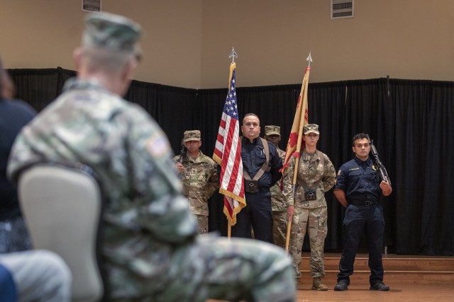 A joint military-civilian color guard stands their post at the U.S. Army Garrison Fort Bliss change of command ceremony at the Centennial Banquet and Conference Center at Fort Bliss, Texas, July 8, 2021.