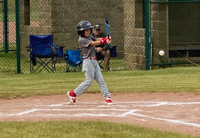 Fort Knox Reds player Michael Johnson gets a hit during the 2021 undefeated season.