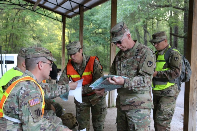Command Sgt. Maj. Mike Dove, U.S. Army Aviation and Missile Command, reviews a terrain map with the five AMCOM Soldiers competing in the command’s Best Warrior Competition May 1, 2019,  at Fort Rucker, Ala.