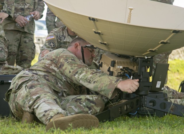 Sgt. Brain Cobb, a multichannel transmission systems operator-maintainer from the 11th Signal Brigade at Fort Hood, makes adjustments to a scalable network node satellite as part of Forager 21, at Andersen Air Force Base, Guam, July 11, 2021. The Army’s ability to employ emerging capabilities rapidly and effectively serves as a blueprint for future force structure and employment. (U.S. Army photo by Spc. Richard Carlisi, I Corps Public Affairs)