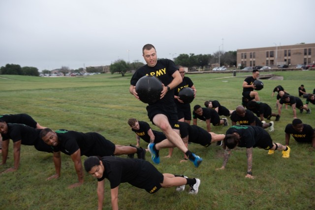 The Green Company Commander, Capt. Stephen Bracken, participates during physical readiness training July 13.  In an effort to continually provide new Soldiers with a beneficial, ever-evolving experience, leaders in the Army’s newest initiative provided Soldiers and cadre with a physical readiness training session hosted by Sgt. 1st Class Latoya Greene, 3rd Cavalry Regiment. (U.S. Army photo by Sgt. 1st Class Kelvin Ringold)