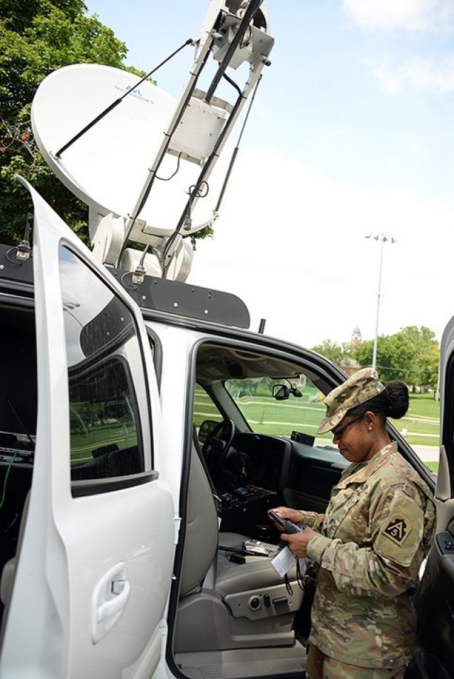 Sgt. Iesha Smith, communications NCO for the Federal Emergency Management Agency, Defense Coordinating Element Region 7, completes a monthly equipment check with a call to FEMA headquarters in Kansas City, Mo., using a satellite phone July 7...