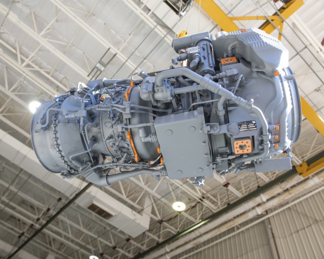 A 3D-printed full-scale model of the GE T901 engine hangs from a sling in the Boeing-Mesa facility during a mock-up Fit Check in an Apache helicopter. Photo Credit: The Boeing Company; GE Aviation; Aviation Turbine Engines Project Office