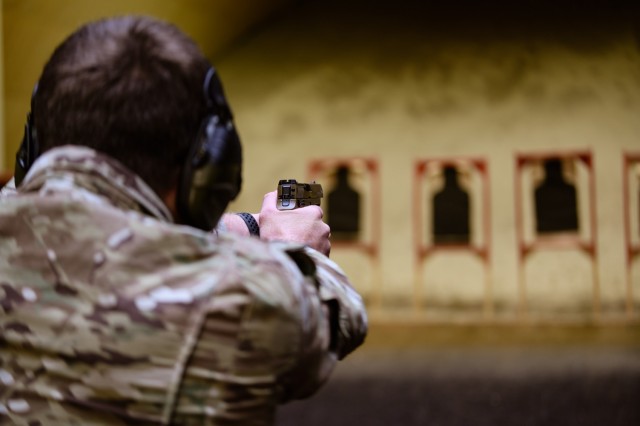 A SOF Soldier takes aim during a Bronze Excellence in Competition (EIC) Pistol match. 