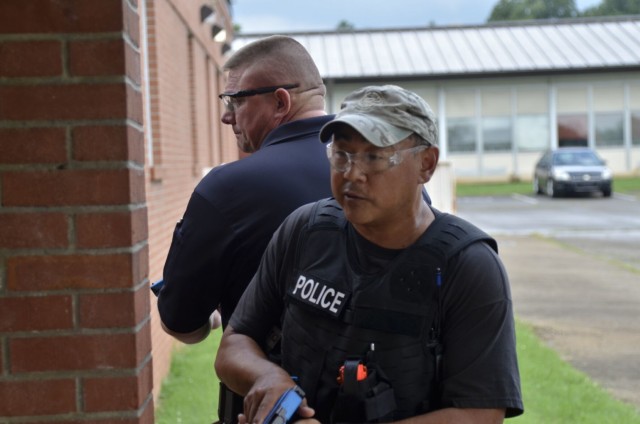 Training officer Erett Oden, Clarksville Police Department, foreground, teams up with Cpl. Robert Reynolds, Montgomery County Sheriff’s Office, to safely enter a building and respond to a simulated threat during Active Attack Integrated Response training, hosted July 12-16 at Jackson Elementary School.