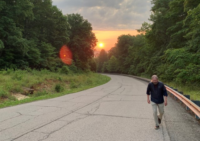 The sun rises over Misery Hill as Goatley makes his third trek toward the summit.