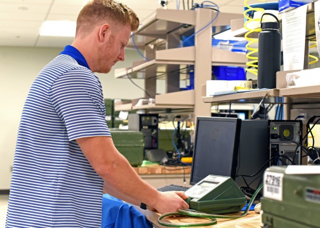 Caleb Baker, an engineering intern from the University of Alabama in Huntsville, demonstrates an “as-found” test conducted on a gas mask tester in the Protection Assessment Test System laboratory at Redstone Arsenal, Ala., April 28. The PATS...