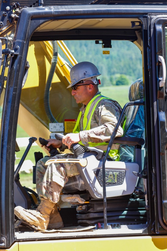 Chief Warrant Officer 2 Raymond Cowden, a construction engineering technician with the Joint Multinational Readiness Center’s Troop Construction Program, backfills some dirt along a 100-meter trench at the Hohenfels Training Area, Hohenfels,...