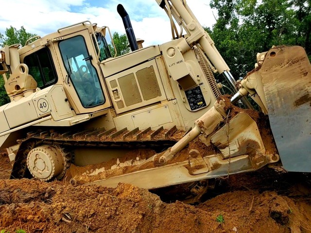 Spc. Seth Abbot with the Wisconsin National Guard's 950th Engineering Company (Route Clearance) operates a bulldozer at a training area July 12, 2021, at Fort McCoy, Wis. The work is part of a troop project coordinated by the Fort McCoy Directorate of Public Works to repurpose and rebuild a training area. The company, which is based in Superior, Wis., is completing the work as part of their annual training. The unit's Soldiers regularly train at Fort McCoy. (U.S. Army Photo by Scott T. Sturkol, Fort McCoy Public Affairs Office)