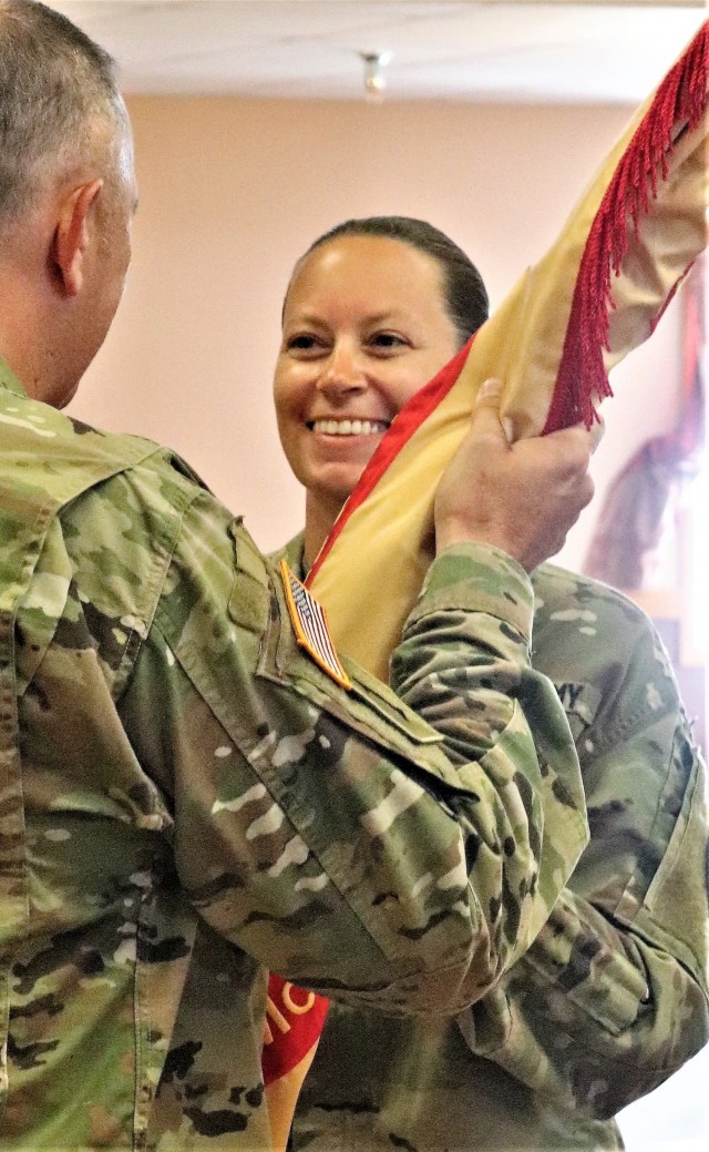 Command Sgt. Maj. Raquel DiDomenico, new Fort McCoy Garrison command sergeant major, receives the garrison flag July 1, 2021, from Garrison Commander Col. Michael Poss during a change of responsibility ceremony at Fort McCoy, Wis. DiDomenico...