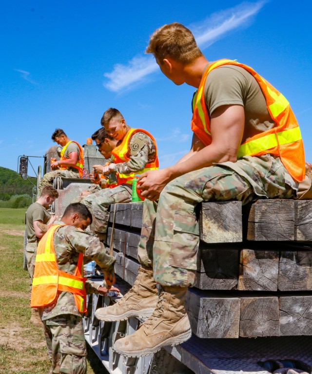 Engineers with third platoon, Argonaut Troop, Regimental Engineer Squadron, 2nd Cavalry Regiment take a break from working on a 100-meter trench on Hohenfels Training Area, Hohenfels, Germany, to eat lunch June 3, 2021. The trench will be utilized...