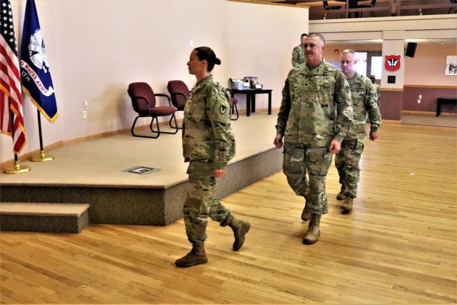 Command Sgt. Maj. Raquel DiDomenico, new Fort McCoy Garrison command sergeant major (CSM); Garrison Commander Col. Michael Poss; and Command Sgt. Maj. Paul Mantha, former garrison CSM, walk in formation back to their seats July 1, 2021, during a...