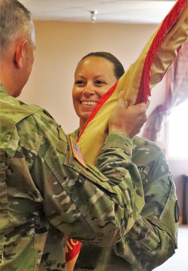 Command Sgt. Maj. Raquel DiDomenico, new Fort McCoy Garrison command sergeant major, receives the garrison flag July 1, 2021, from Garrison Commander Col. Michael Poss during a change of responsibility ceremony at Fort McCoy, Wis. DiDomenico...