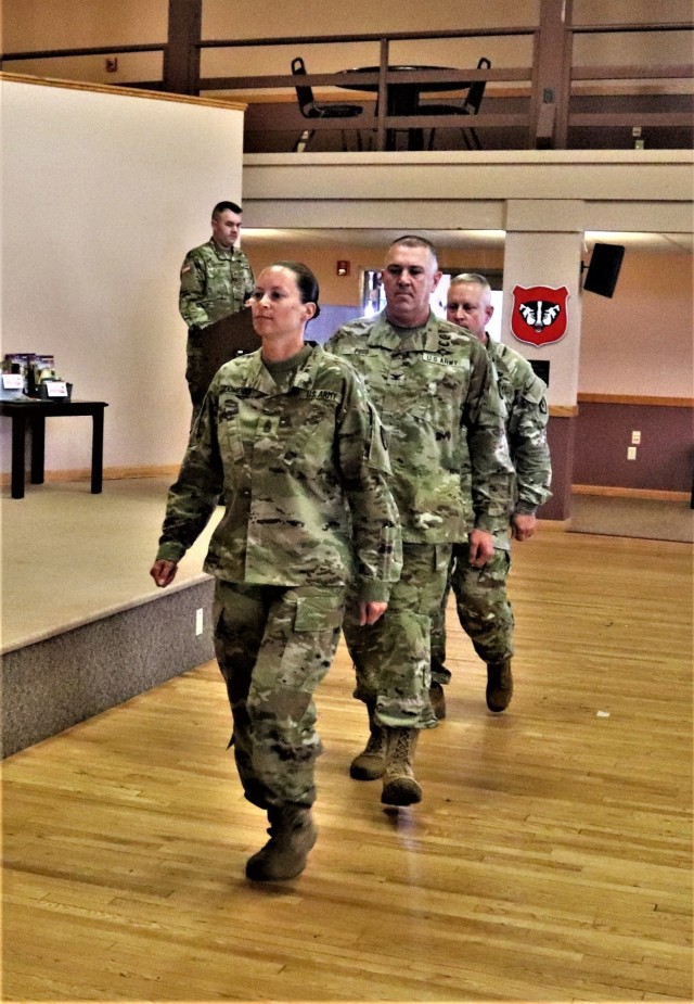 Command Sgt. Maj. Raquel DiDomenico, new Fort McCoy Garrison command sergeant major (CSM); Garrison Commander Col. Michael Poss; and Command Sgt. Maj. Paul Mantha, former garrison CSM, walk in formation back to their seats July 1, 2021, during a CSM change of responsibility ceremony at Fort McCoy, Wis. DiDomenico replaced Mantha as the garrison command sergeant major during the ceremony. She has previously served at Fort McCoy at the Fort McCoy Noncommissioned Officer Academy. A CSM is the most senior enlisted member of a color-bearing Army unit. The CSM is appointed to serve as a spokesman to address the issues of all Soldiers, from enlisted to officers, from warrant officers and lieutenants to the Army's highest positions. As such, they are the senior enlisted advisor to the commander. The exact duties vary depending on the unit commander, including observing training and talking with Soldiers and their families. (U.S. Army Photo by Scott T. Sturkol, Public Affairs Office, Fort McCoy, Wis.)