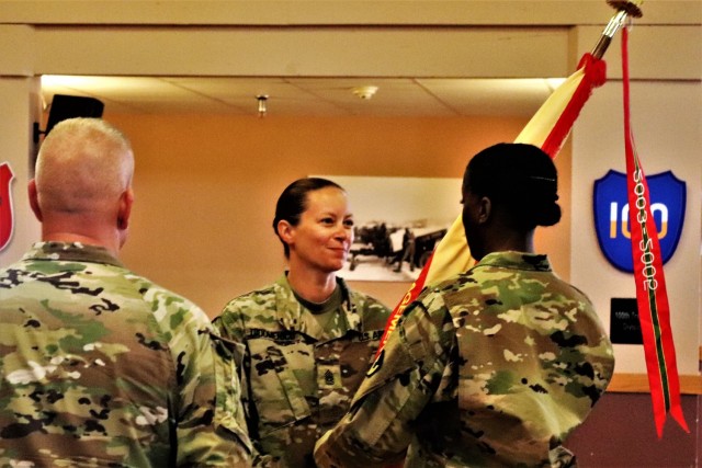 Command Sgt. Maj. Raquel DiDomenico, new Fort McCoy Garrison command sergeant major, passes the garrison flag back to 1st Sgt. Lauren Phillips, garrison first sergeant, July 1, 2021, during a change of responsibility ceremony at Fort McCoy, Wis....