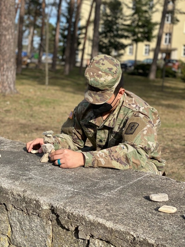 A Soldier demonstrates mindfulness rock stacking activity to RRC participants. U.S. Army photo by Maj. Ashley Welsh.