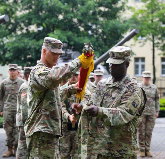 The 53rd Movement Control Battalion Commander Lt. Col. Aaron Cornett and Command Sgt. Maj. LaVaughn Brown case their colors during a transfer of authority ceremony in Żagań, Poland, July 14, 2021. Members of the 53rd completed a nine-month...