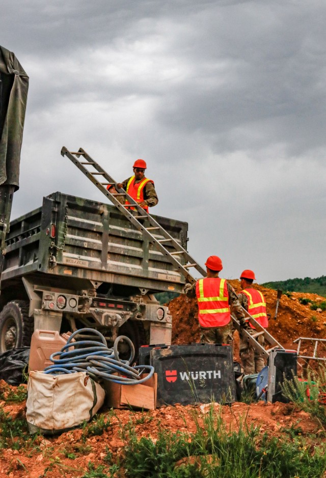 Pvt. Leon Grant, a horizontal construction engineer with third platoon, Argonaut Troop, Regimental Engineer Squadron, unloads a ladder from a truck as construction on a 100-meter trench begins June 4, 2021 on Hohenfels Training Area, Hohenfels,...
